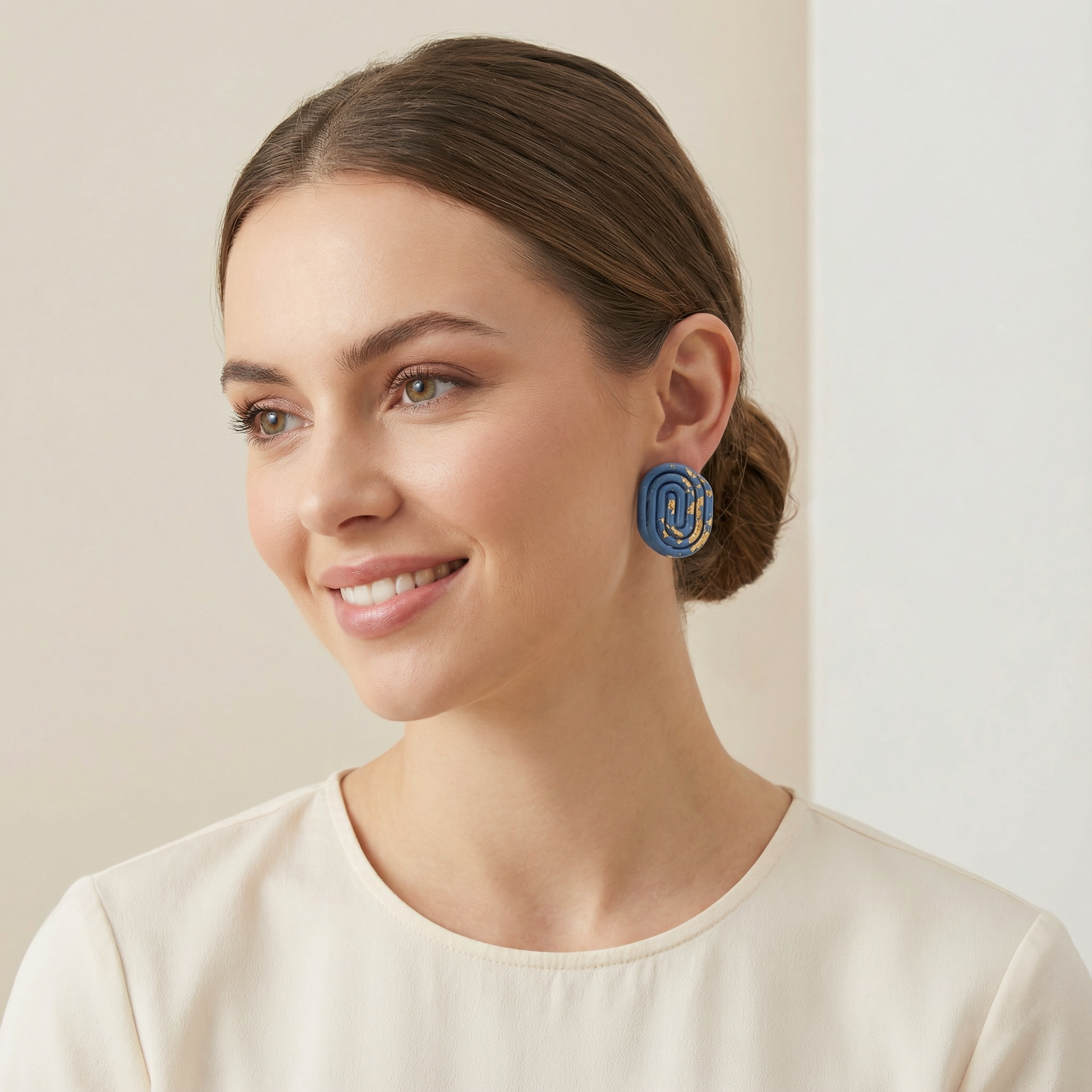 Blue spiral handmade clay stud earrings with gold accents